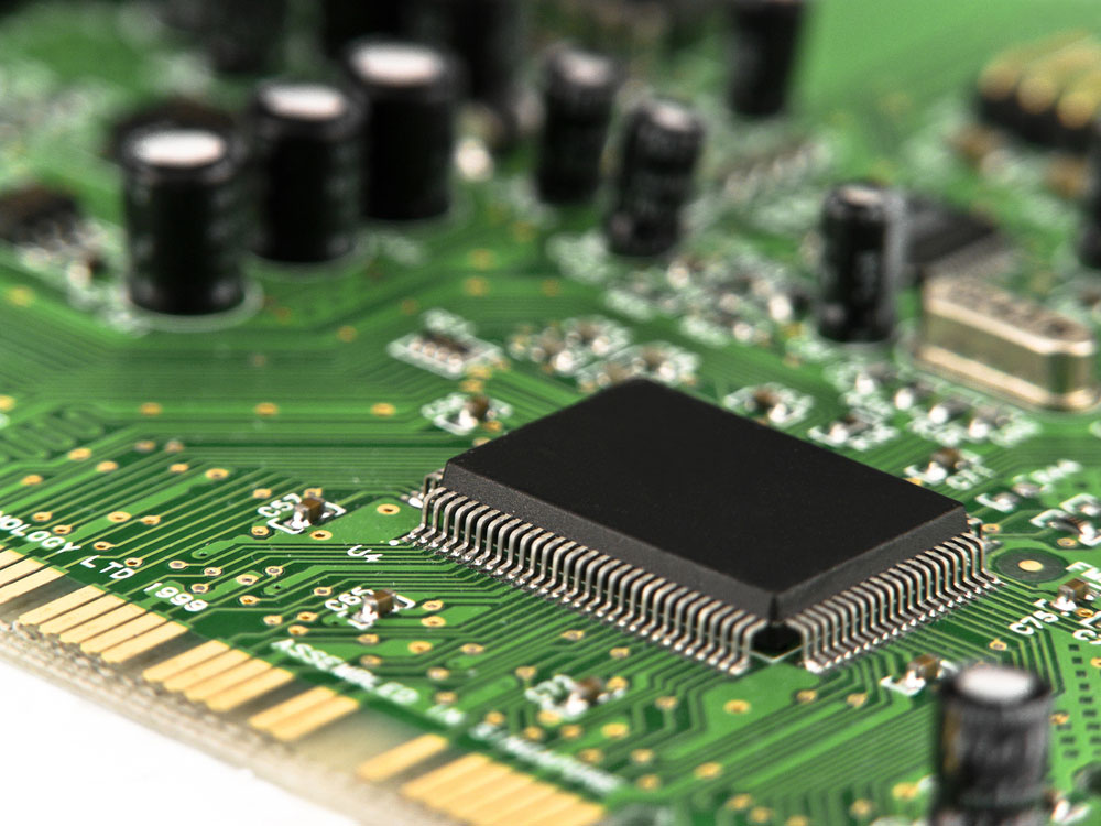 Several Capacitors and Microchips on a PCB