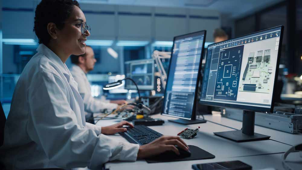 Engineers in an electronics production plant designing PCBs 